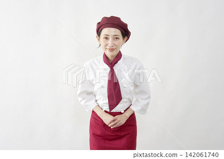 Female pastry chef/baker/cafe employee, bowing, white background, looking at the camera. Female pastry chef/baker/cafe employee, bowing, white background, looking at the camera. 142061740