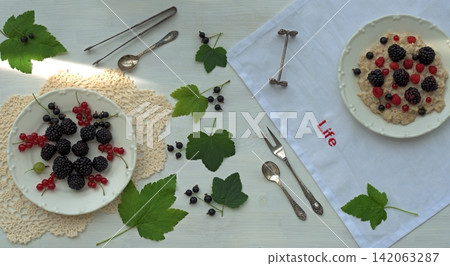 Bowls of oatmeal and berries, top view Bowls of oatmeal and berries, top view 142063287