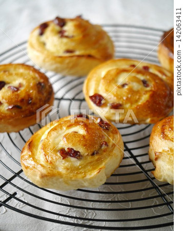 Freshly baked cranberry cheese roll Freshly baked cranberry cheese roll 142063411