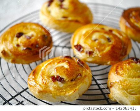 Freshly baked cranberry cheese roll Freshly baked cranberry cheese roll 142063413