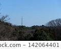 Transmission towers and power lines in the mountains 142064401