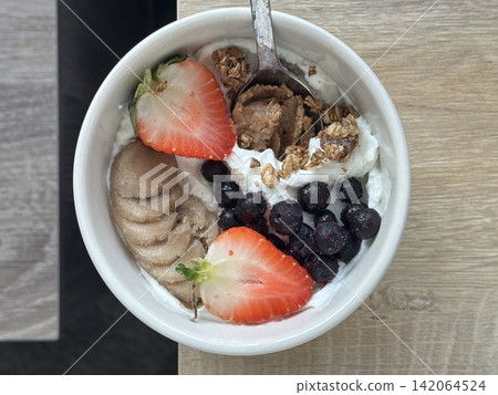 Creamy yogurt bowl topped with fresh fruits and crunchy toppings, offering a smooth texture and refreshing taste. Light, wholesome, and visually appealing, perfect for breakfast or healthy snack. Creamy yogurt bowl topped with fresh fruits and crunchy toppings, offering a smooth texture and refreshing taste. Light, wholesome, and visually appealing, perfect for breakfast or healthy snack. 142064524