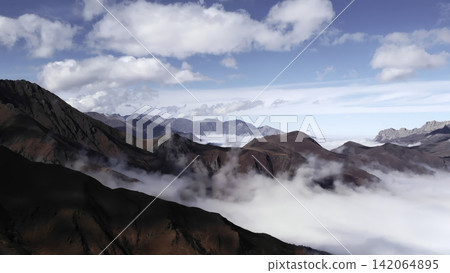 Aerial view of dramatic mountain peaks above a sea of clouds in bright daylight . Media Aerial view of dramatic mountain peaks above a sea of clouds in bright daylight . Media 142064895