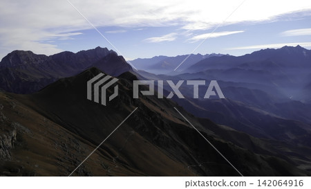 Panoramic rugged mountain range in clear daylight Panoramic rugged mountain range in clear daylight 142064916