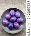 A Beautiful Collection of Purple Easter Eggs Nestled in a Gray Bowl, Showcasing Stunning Marbled Patterns and Colors for the Spring Celebration. 142065328