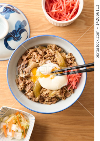 Beef bowl topped with a soft-boiled egg Beef bowl topped with a soft-boiled egg 142066113