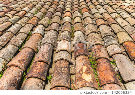 Aged terracotta roof tiles texture on traditional medieval building in Rupit, Catalonia, Spain Aged terracotta roof tiles texture on traditional medieval building in Rupit, Catalonia, Spain 142066324