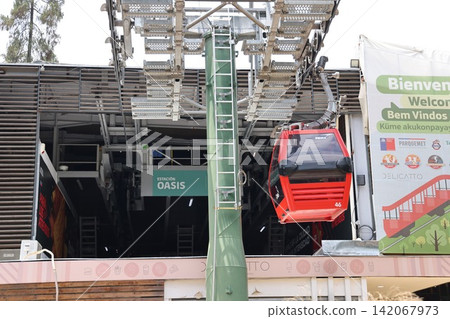 The red gondola lift arrives at Santiago's Oasis Station. The red gondola lift arrives at Santiago's Oasis Station. 142067973