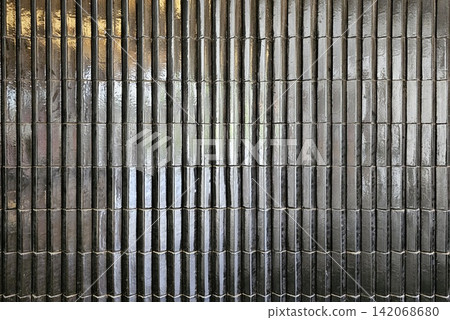 Glossy black tile vertical ribbed wall surface background for professional interior design presentation. Glossy black tile vertical ribbed wall surface background for professional interior design presentation. 142068680