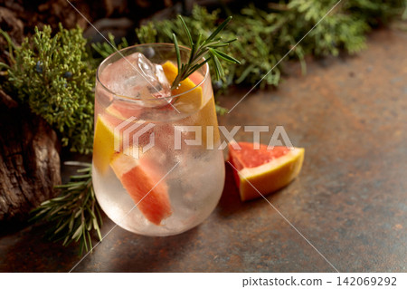 Refreshing hard seltzer with ice, grapefruit, and rosemary. Refreshing hard seltzer with ice, grapefruit, and rosemary. 142069292