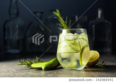 Cocktail gin tonic with ice, rosemary, lime, and cucumber. Cocktail gin tonic with ice, rosemary, lime, and cucumber. 142069341