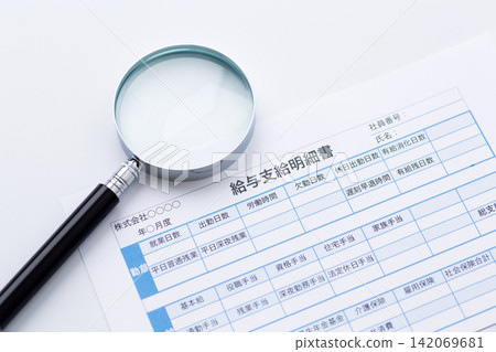 Pay slip and magnifying glass Pay slip and magnifying glass 142069681