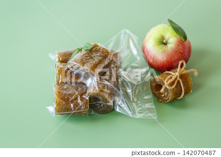 Natural apple pastila in sealed package on green background Natural apple pastila in sealed package on green background 142070487