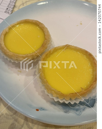 Golden egg tart with a flaky, buttery crust and a rich, creamy custard center. A deliciously satisfying treat for dessert or a light snack, blending texture and flavor perfectly. Golden egg tart with a flaky, buttery crust and a rich, creamy custard center. A deliciously satisfying treat for dessert or a light snack, blending texture and flavor perfectly. 142070744