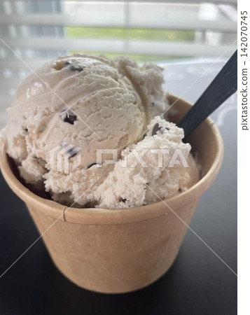 Creamy, smooth ice cream with rich flavor and a melt in your mouth texture, offering a perfect sweet treat to cool down and indulge in every delicious, refreshing scoop. 142070745