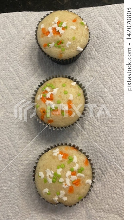A delightful cupcake topped with rich frosting and decorative sprinkles. Perfect for dessert photography, showcasing the charm and sweetness of baked goods, ideal for parties and celebrations. A delightful cupcake topped with rich frosting and decorative sprinkles. Perfect for dessert photography, showcasing the charm and sweetness of baked goods, ideal for parties and celebrations. 142070803