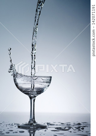 puring refreshment freshness drinking water on clean transperence glass in studio back light puring refreshment freshness drinking water on clean transperence glass in studio back light 142071191