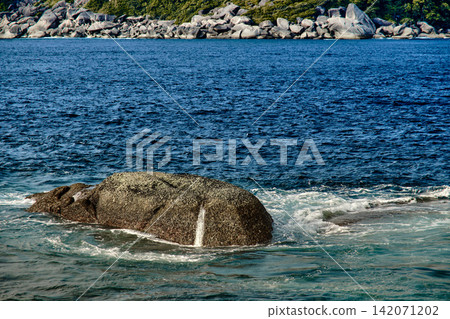 sea wave hitting the rock in rocky shore of the island sea wave hitting the rock in rocky shore of the island 142071202