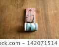 Hundred dollar bills caught in wooden mousetrap 142071514