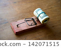 Hundred dollar bills caught in wooden mousetrap 142071515