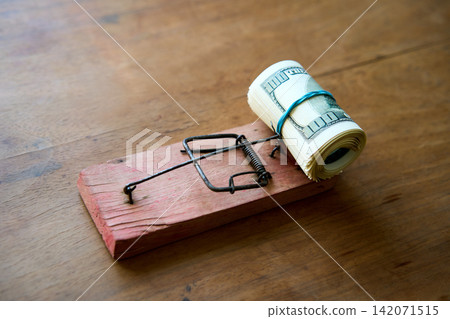 Hundred dollar bills caught in wooden mousetrap Hundred dollar bills caught in wooden mousetrap 142071515