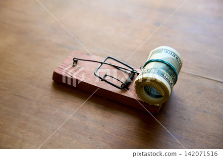 Hundred dollar bills caught in wooden mousetrap Hundred dollar bills caught in wooden mousetrap 142071516