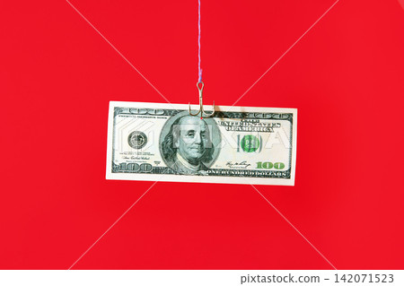 Dollar bill on hook over red background Dollar bill on hook over red background 142071523
