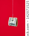 One hundred dollar bill on fishing hook over red background 142071525