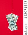 Dollar bills on hook over red background 142071526