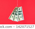 Dollar bills on hook over red background 142071527