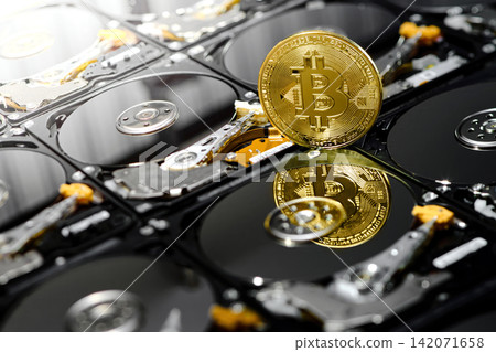 one bitcoin isolated standing belong naked hard disk drives with reflection on data disc for background wallpaper in internet business finance crypto currency banking scene one bitcoin isolated standing belong naked hard disk drives with reflection on data disc for background wallpaper in internet business finance crypto currency banking scene 142071658