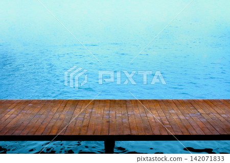 a wet poolside walk way bridge with blue sea a wet poolside walk way bridge with blue sea 142071833