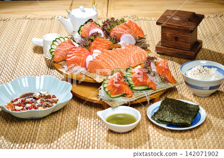 salmon sashimi raw fish freshness Asian japan food in the traditional wooden dish with natural wicker placemat salmon sashimi raw fish freshness Asian japan food in the traditional wooden dish with natural wicker placemat 142071902