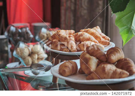 many croissants in many trays awaited to be served to the business conference attendees during the coffee break. 142071972