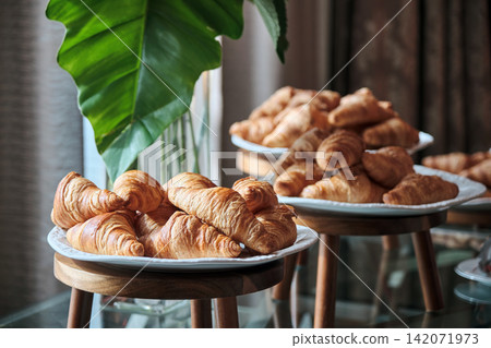 many croissants in many trays awaited to be served to the business conference attendees during the coffee break. many croissants in many trays awaited to be served to the business conference attendees during the coffee break. 142071973