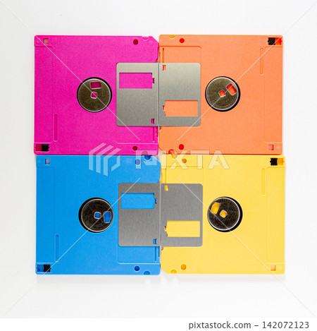 Four Colorful Floppy Disks in Grid Arrangement on White Background Four Colorful Floppy Disks in Grid Arrangement on White Background 142072123
