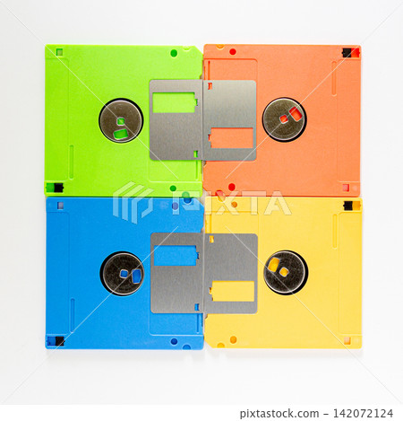 Four Colorful Floppy Disks in Grid Arrangement on White Background Four Colorful Floppy Disks in Grid Arrangement on White Background 142072124