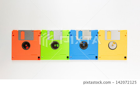 Colorful Floppy Disks in a Row on White Background Retro Technology Colorful Floppy Disks in a Row on White Background Retro Technology 142072125