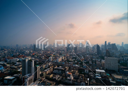 Cityscape photo show traffic jams on the highway of a big city in evening cover by dust mist that made two color sky Cityscape photo show traffic jams on the highway of a big city in evening cover by dust mist that made two color sky 142072701