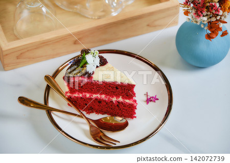 a single piece of red velvet strawberry cake with white chocolate cover and choco sauce a single piece of red velvet strawberry cake with white chocolate cover and choco sauce 142072739
