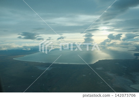 A view of the Pacific coastline and sunlight shining through the clouds from above Santiago, Chile. A view of the Pacific coastline and sunlight shining through the clouds from above Santiago, Chile. 142073706