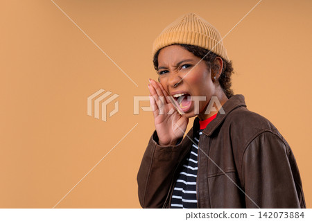 Young Teenage Girl Shouting With Hand Near Open Mouth, Calling For Attention Or Sharing Urgent Young Teenage Girl Shouting With Hand Near Open Mouth, Calling For Attention Or Sharing Urgent 142073884