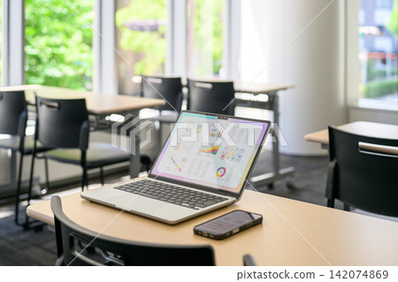 A laptop and a smartphone placed on the desk A laptop and a smartphone placed on the desk 142074869