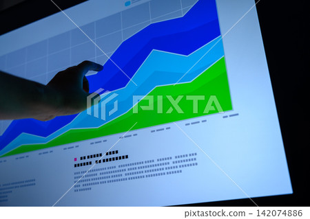 A hand pointing at a graph, an image of data analysis. A hand pointing at a graph, an image of data analysis. 142074886
