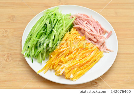Ingredients for chilled ramen (shredded cucumber, ham, shredded egg omelet) Ingredients for chilled ramen (shredded cucumber, ham, shredded egg omelet) 142076400