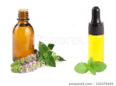 bottle of peppermint oil and fresh mint isolated on white background bottle of peppermint oil and fresh mint isolated on white background 142076484