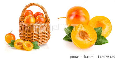 yellow plums in a wicker basket with leaf isolated on white background yellow plums in a wicker basket with leaf isolated on white background 142076489