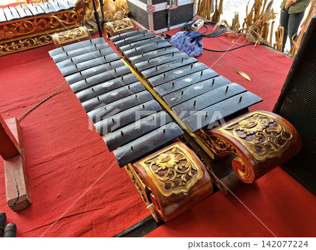 Indonesian percussion instruments, metal xylophone style, ethnic musical ensemble, traditional cultural heritage orchestra. Indonesian percussion instruments, metal xylophone style, ethnic musical ensemble, traditional cultural heritage orchestra. 142077224