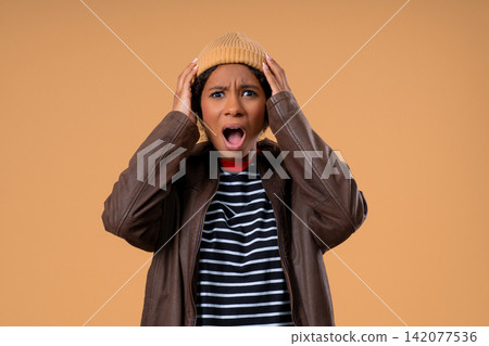 Angry African Teenage girl Yelling At Camera With Expressive Face In Frustration. Lady in stress and Angry African Teenage girl Yelling At Camera With Expressive Face In Frustration. Lady in stress and 142077536