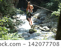 Adventure Seeker Enjoys Thrilling Zipline Ride Over River 142077708